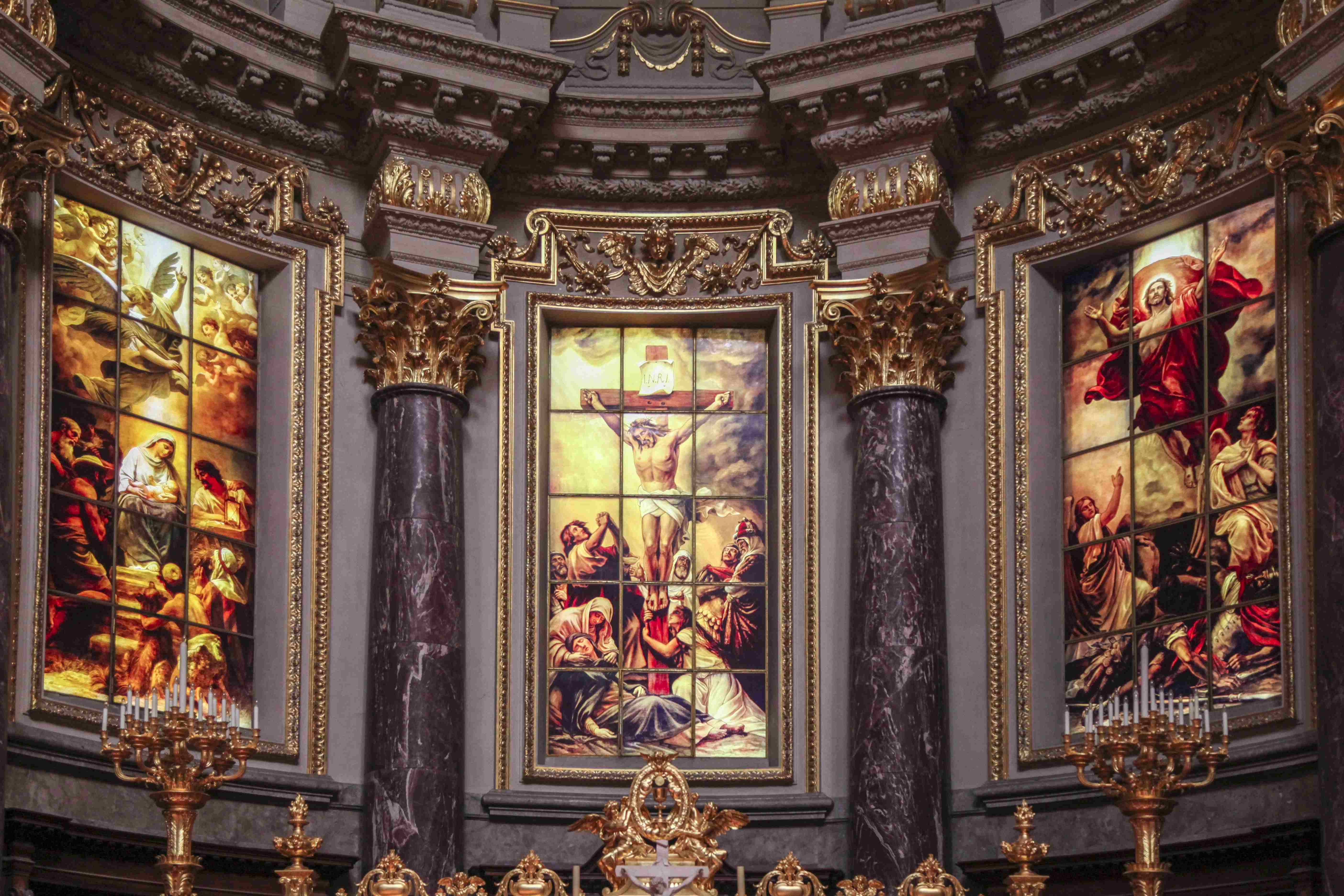 Stained-glass scenes of Christ inside a Catholic church